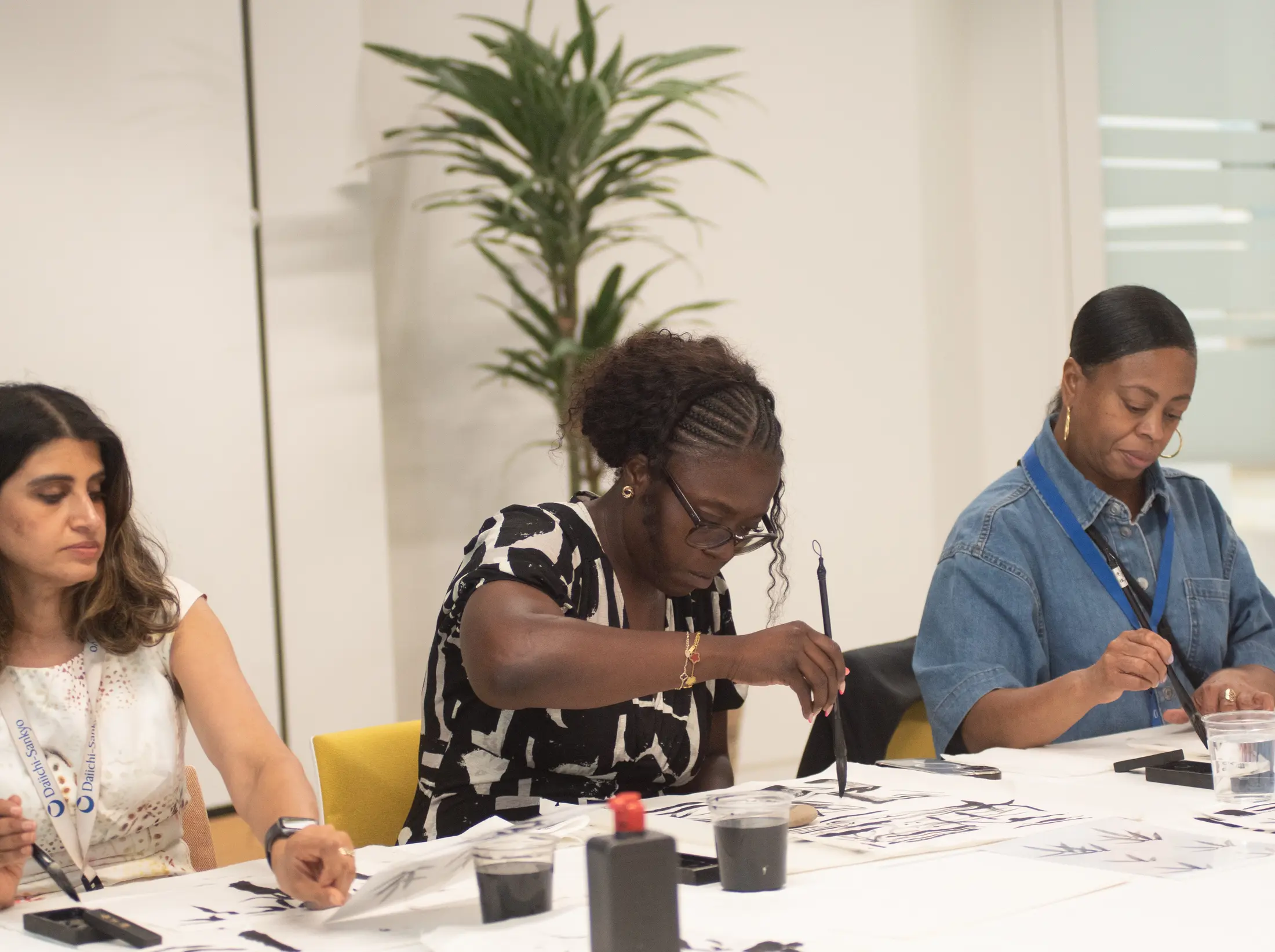 Focused brushwork during a Sumi-e workplace wellbeing session